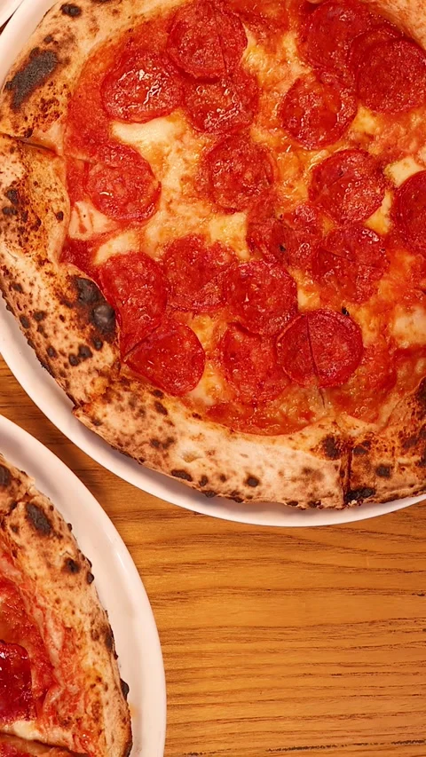 Overhead View of Pepperoni Pizza and Red Wine on Wooden Table Stock Footage 337860407