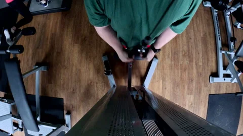 Overhead view of person using cable machine in gym Stock Footage 276958852