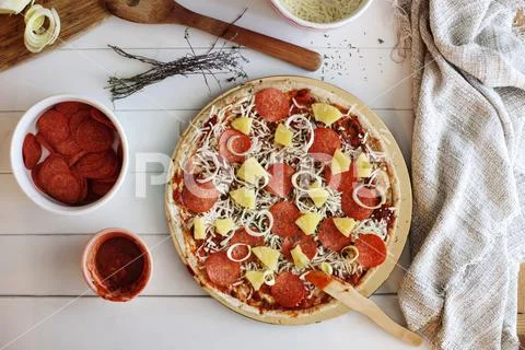 Overhead view of pizza being prepared at home Stock Photos