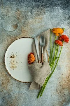 Overhead view of a place setting with ranunculus flowers Stock Photos
