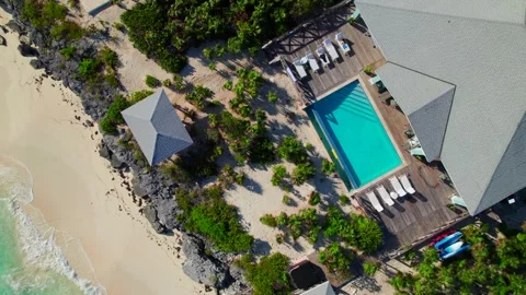 Overhead view of pool deck, chairs and beachfront at luxury Caribbean villa, 4K Stock Footage 334818078