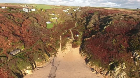 Overhead view of Porthcurno sandy beach, panning out to reveal aquamarine Stock Footage 88686869