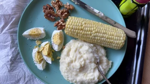 Overhead view of potatoes and corn girl dinner 스톡 동영상 247663168
