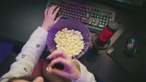 Overhead view of programmer working with microphone and popcorn on desk Stock Footage 307459814