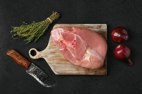 Overhead view of raw slice of beef steamship round with cooking ingredients o Stock Photos