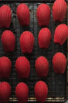 Overhead view of red madeleines cake or cookies on baking rack Stock Photos