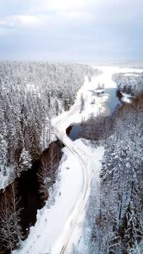 Overhead view of a road through a snow covered forest landscape Stock Photos
