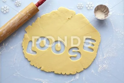 Overhead View Of Rolled Out Suger Cookie Dough With Loose Cut Out Of It, Studio