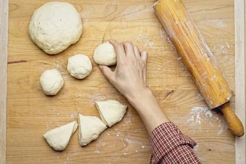 Overhead view of rolling dough into balls. Stock Photos