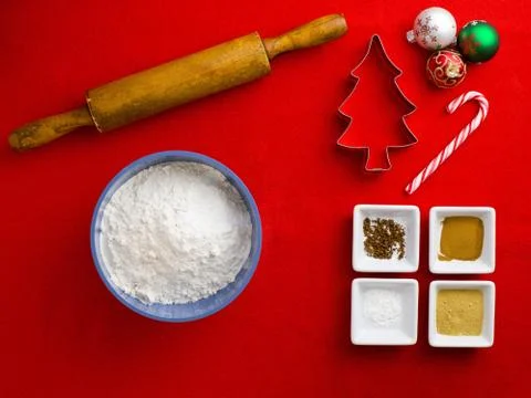 Overhead view of rolling pin with candy cane and cookie cutter with cake ingr Stock-Fotos