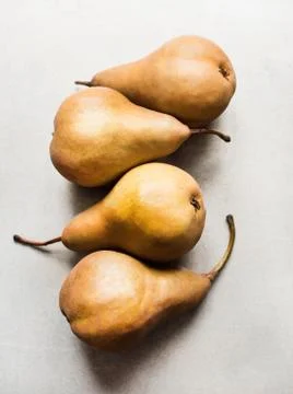 Overhead view of a row of four pears Stock Photos
