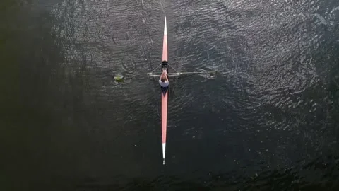 Overhead View of Rower Gliding Through Flowing Water Видео 345936664