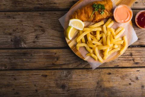 Overhead view of seafood with french fries and sauce on table, copy space Stock Photos