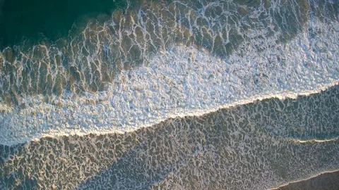 Overhead view of the seaside with waves breaking and dying and foam patterns. Stock Footage 86262689