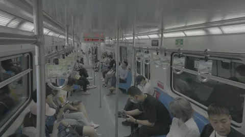 Overhead View of Seated Passengers in Beijing Subway Car Видео 341457169