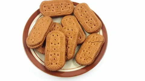 Overhead view of several oblong biscuits slowly spinning, food video. Stock Footage 329909979