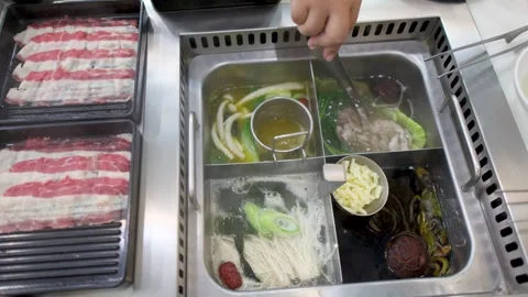 Overhead View of Sliced Beef and Vegetables Cooking in Hot Pot Stock Footage 334161569