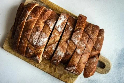 Overhead view of a sliced loaf of bread on a chopping board Stock Photos
