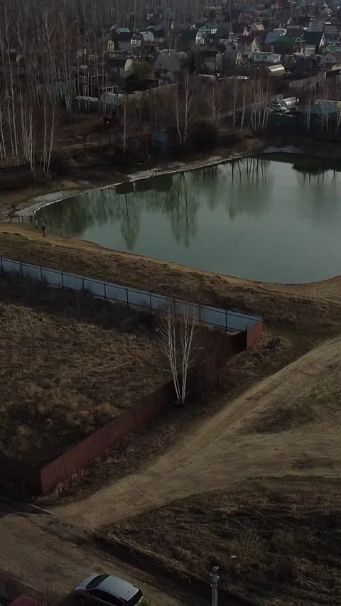 Overhead view of a small pond with a surrounding fence Video stock 347499050