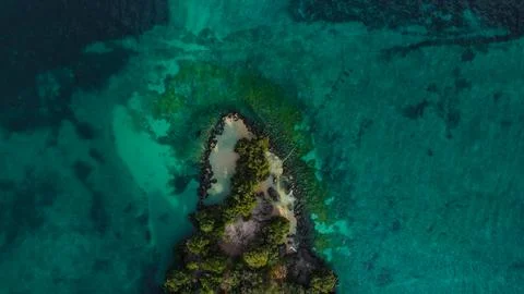 Overhead view of a small, secluded tropical island surrounded by deep water Stock Photos