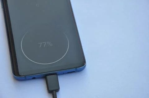 Overhead view of a smartphone connected with USB Type-C charging cable  Stock Photos
