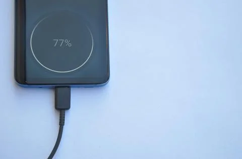Overhead view of a smartphone connected with USB Type-C charging cable  Stock Photos