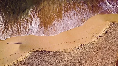 Overhead View Of A Solo Man Walking Down A Deserted Tropical Beach 스톡 동영상 83959738