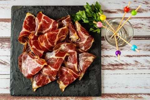 Overhead view of some exquisite fetas de bondiola or raw pickled pork on a bl Stock Photos