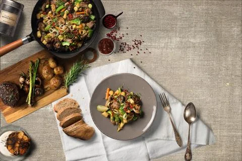 Overhead view steak on a rustic wooden counter in a dinner steakhouse Stock Illustration
