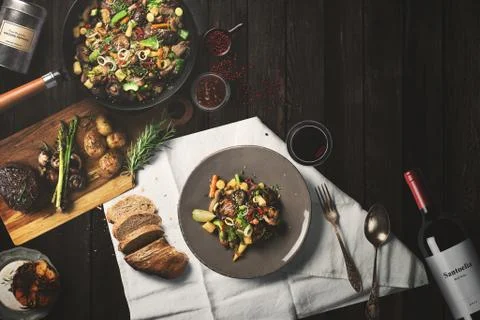 Overhead view steak on a rustic wooden counter in a dinner steakhouse Stock Illustration