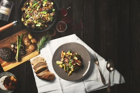 Overhead view steak on a rustic wooden counter in a dinner steakhouse Stock Illustration