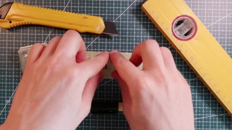 Overhead view of sticking PROJECT PLAN tape label near spirit level. Stock Footage 337816246