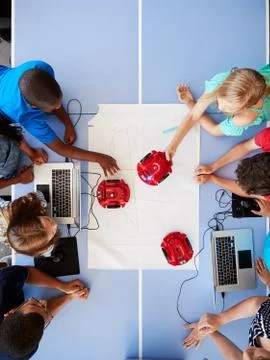 Overhead View Of Students In After School Computer Coding Class Learning To Stock Photos