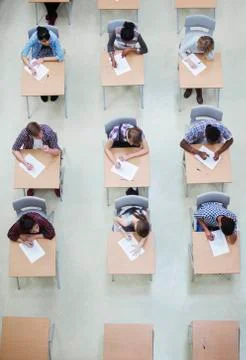 Overhead view of students writing their GCSE examination Stock Photos