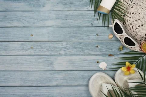Overhead view of summer beach essentials including sunglasses, a straw hat, Stock Photos