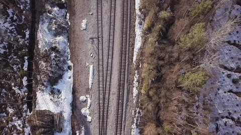Overhead view of three railroad tracks with springtime forest surrounding Video stock 116096781