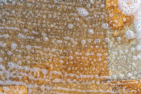 Overhead view of tile with soap and water forming a pattern of foam bubbles Stock Photos