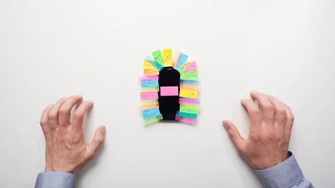Overhead view Time-lapse of a man putting post it notes onto a smartphone Stock Footage