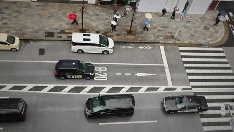Overhead View of Tokyo Traffic Driving Through City Street Stock Footage 335103016