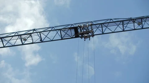 Overhead view of tower crane boom against blue sky Stock Footage 314234251