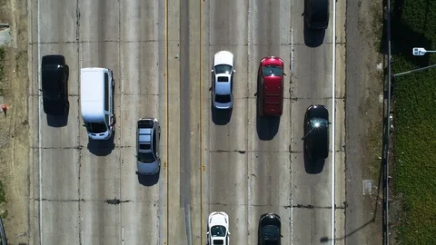 Overhead view of traffic driving on freeway. Aerial shot Stock Footage