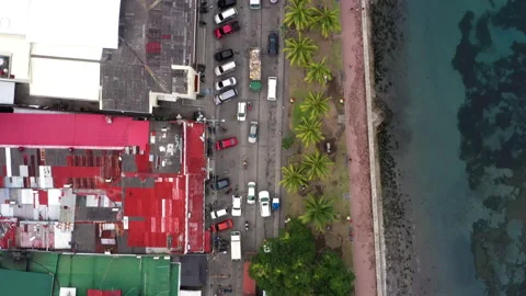 Overhead view of traffic on a road besides the ocean in Philippines 4k Stock Footage 265105579
