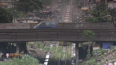 Overhead view of train passing through slums in Lagos. Stock Footage 86760934