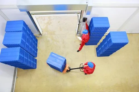 Overhead view of two workers working in small warehouse Stock Photos