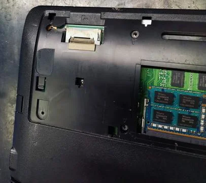 An overhead view of the underside of a disassembled laptop computer, revealing Stock Photos