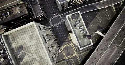 Overhead view of urban intersection showing buildings and streets in a city Ilustración de archivo