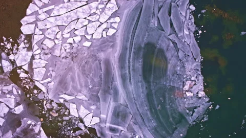 Overhead view of varied ice sheets covering the surface of a northern Michigan Stock Footage 338410347