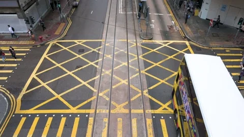 Overhead View of Vehicles at Road Intersection with Yellow Grid &amp; Zebra 動画素材 294674872