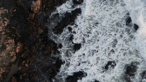 Overhead view of the waves crashing against the coastal rocks Stock Footage 157450059