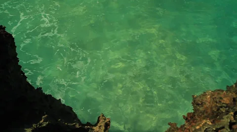 Overhead View Waves Crashing into Rocks Stock Footage 34796621